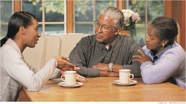 Grown daughter talking to parents at home
